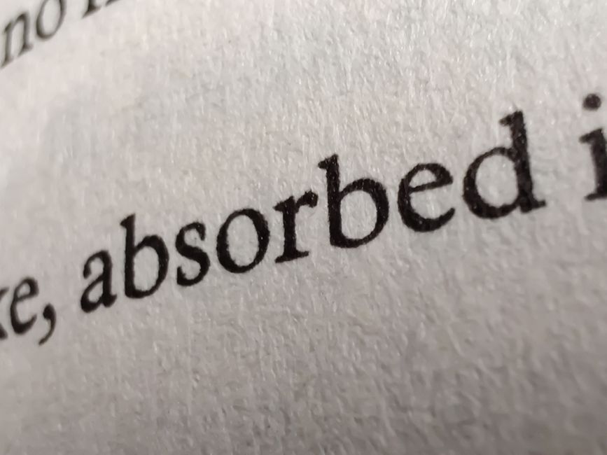Close review of curved text generator spacing and kerning on a printed logo proof
