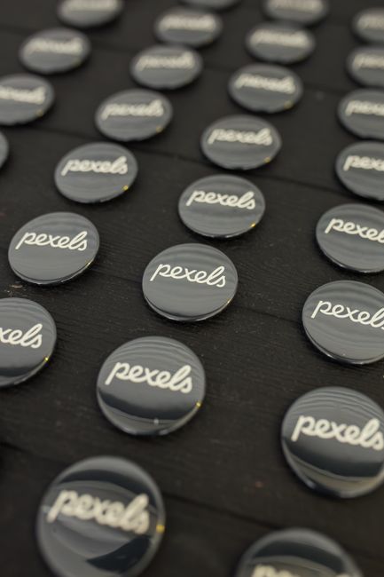 Printed circular badge showing a curved text generator logo concept with icon-centered framing