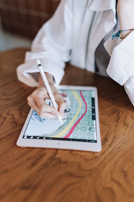 Designer planning a curved text generator logo layout on a digital tablet